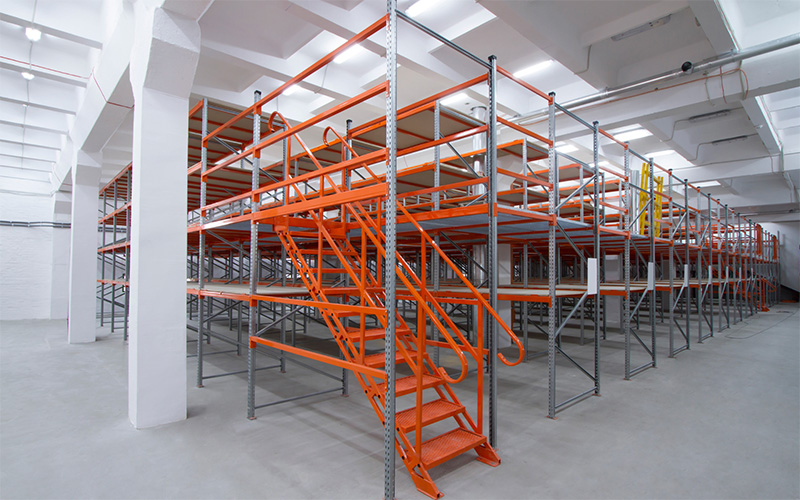 A large warehouse with orange mezzanine flooring system.